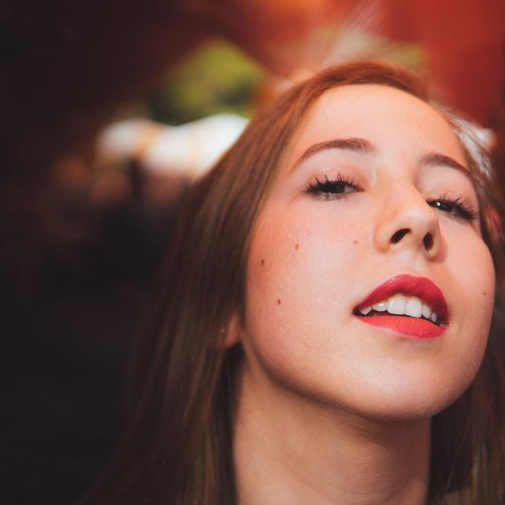 Alex Kim, Lead Design Curator at FolioHarborCrest, reviewing corporate floral arrangements